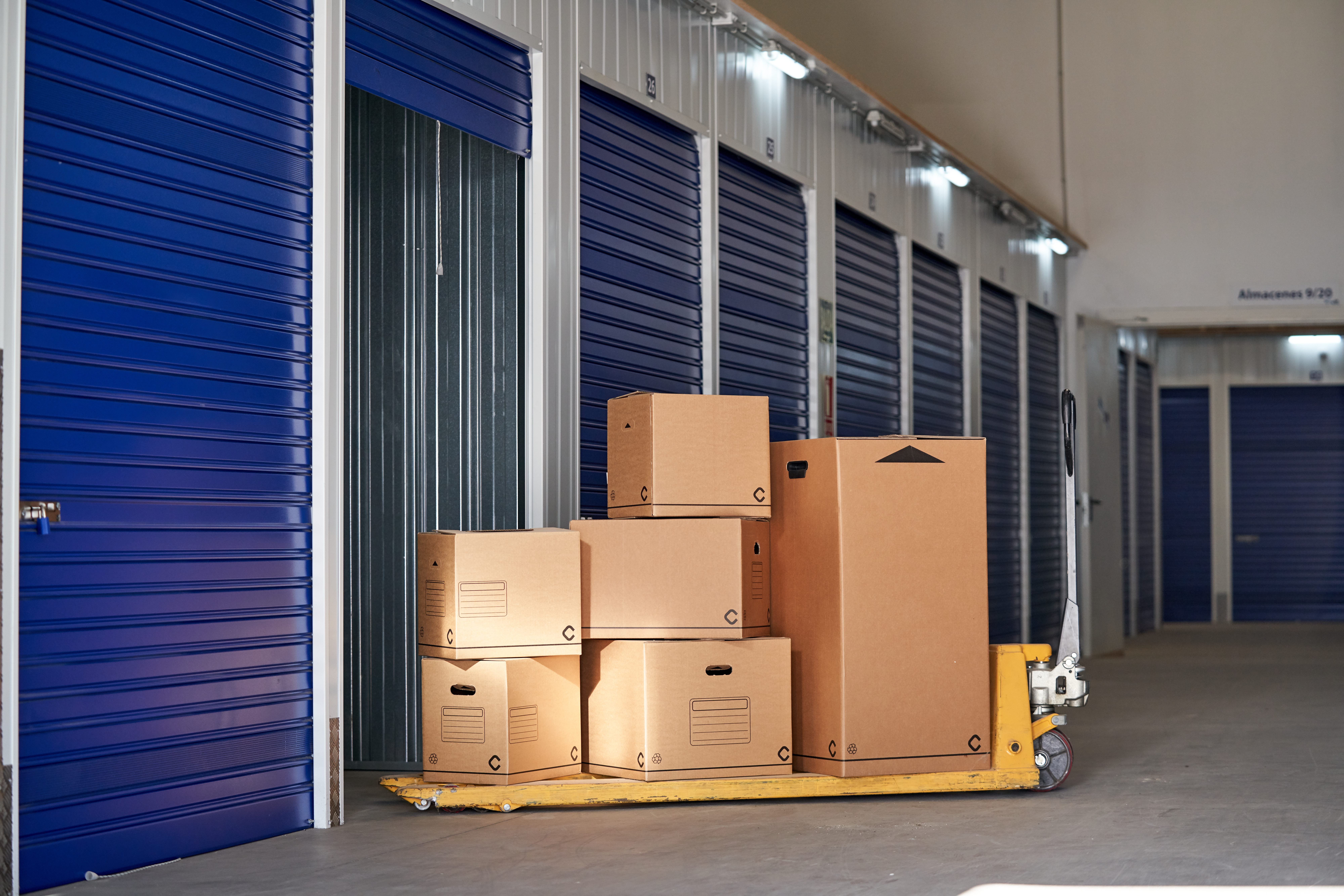 Storage in an industrial building for rental to entrepreneurs or individuals with recyclable cardboard boxes on top of a pallet rack